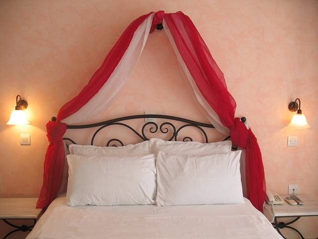 Double studio with canopy bed and bedside lamps at Anna Villas